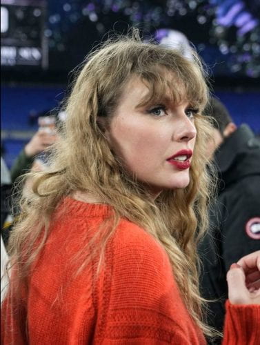 taylor swift in a red sweater and red lipstick
